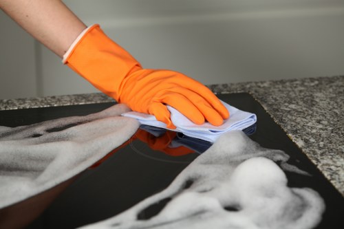 Professional carpet cleaning team applying safe working practices with equipment and floor protection